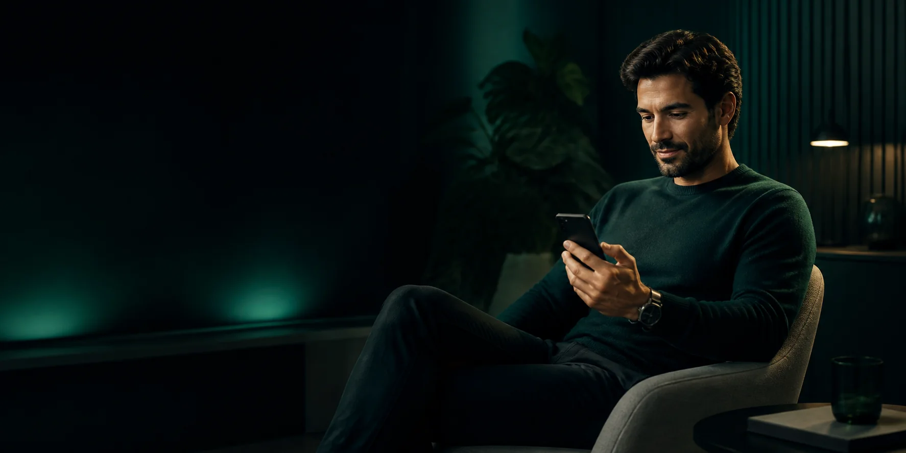 A person checking a smartphone while seated in a lounge